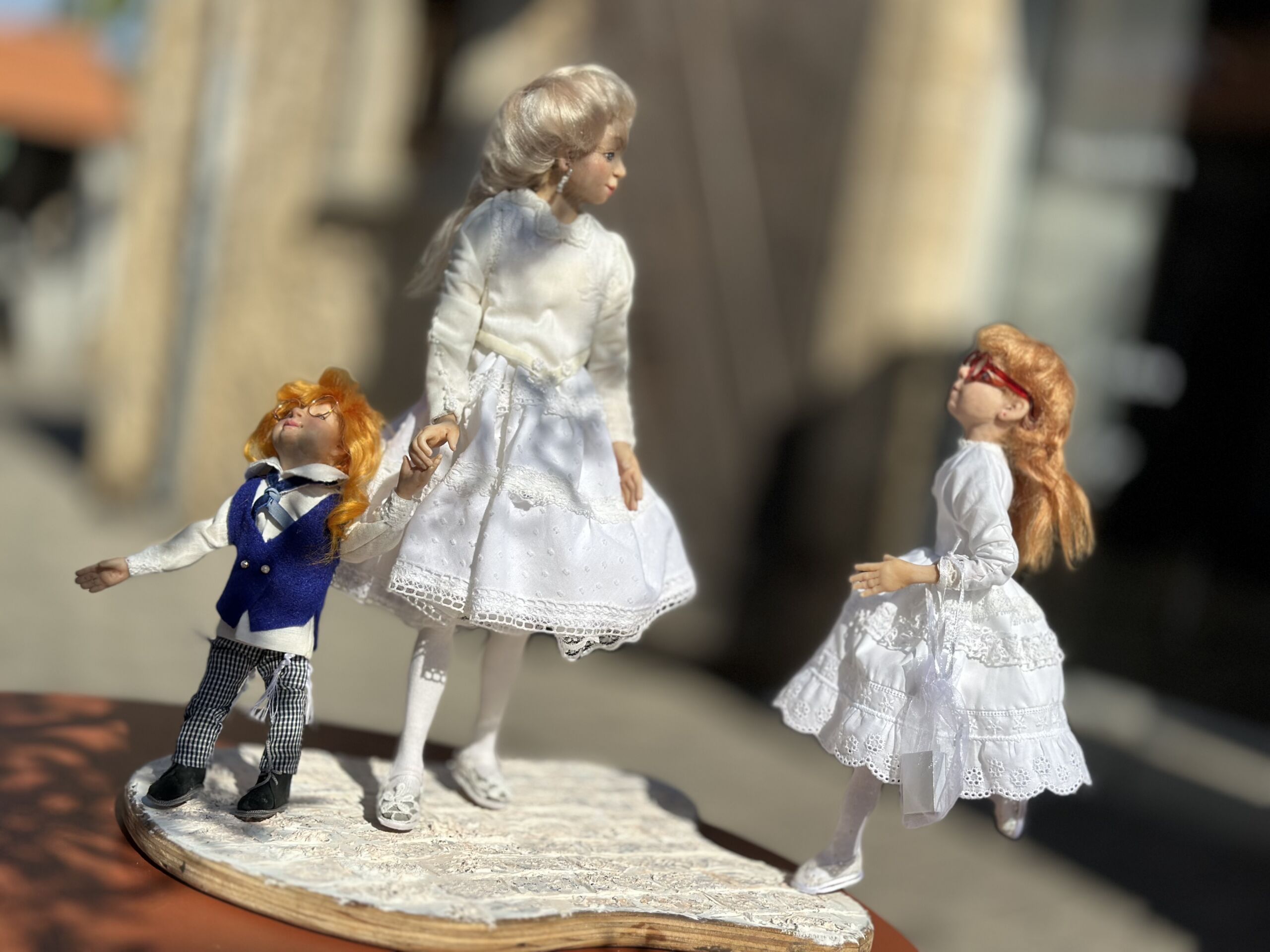 Bright Day “Bright Day” is a handmade figurative composition inspired by quiet moments of Jewish family life. The scene captures a feeling of warmth, light, and togetherness — as if the family has stepped out for a peaceful Shabbat walk, suspended for a moment between conversation, sunlight, and stillness. Each character carries an individual presence and emotion, while together they create a gentle narrative about connection, tradition, and the simple beauty of being close to one another. Created entirely by hand, this one-of-a-kind sculptural work reflects themes of family, memory, and everyday tenderness within Jewish life and culture.